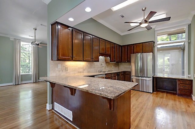 2707 Lookout Dr, Columbus, GA 31906 - kitchen featuring stainless steel appliances, ceiling fan, ornamental molding, a peninsula, and light stone counters
