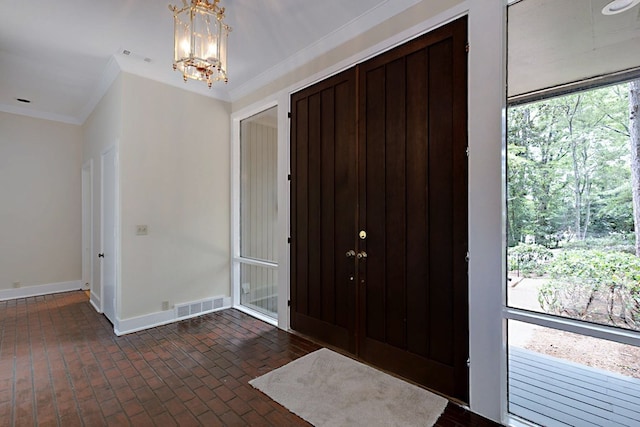 2707 Lookout Dr, Columbus, GA 31906 - foyer entrance with brick floors, a chandelier, and ornamental molding