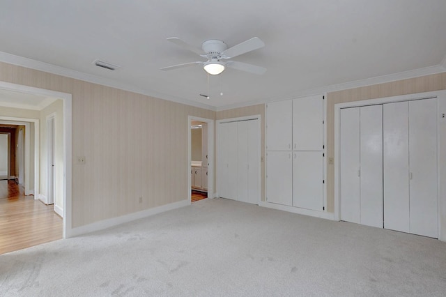2707 Lookout Dr, Columbus, GA 31906 - unfurnished bedroom featuring two closets, crown molding, light colored carpet, a ceiling fan, and ensuite bathroom