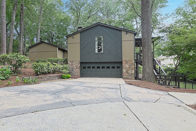 2707 Lookout Dr, Columbus, GA 31906 - view of front facade with stone siding, driveway, an attached garage, and stairway