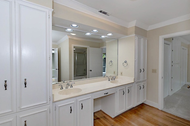 2707 Lookout Dr, Columbus, GA 31906 - bathroom featuring ornamental molding, double vanity, a shower with shower door, recessed lighting, and wood finished floors