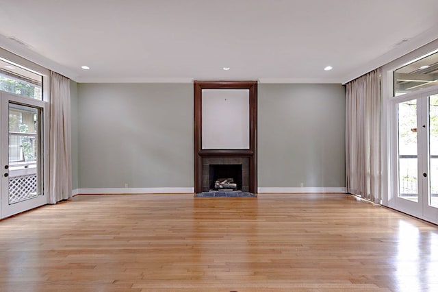 2707 Lookout Dr, Columbus, GA 31906 - unfurnished living room featuring healthy amount of natural light, a fireplace, french doors, light wood-style flooring, and recessed lighting