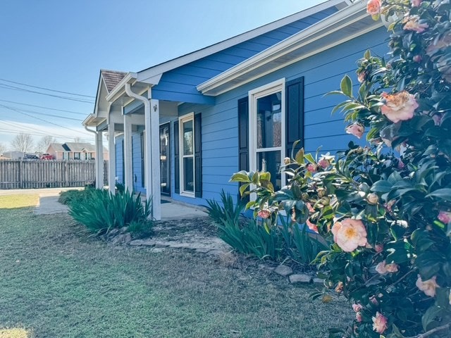 view of side of property featuring fence