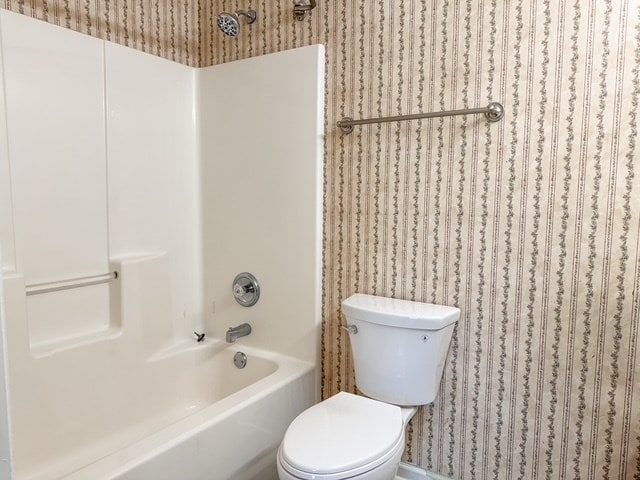 full bath featuring tub / shower combination and toilet