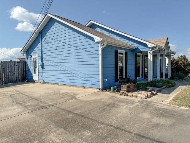 view of property exterior with fence