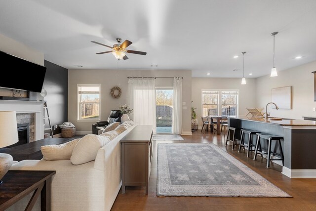 kitchen with pendant lighting, stainless steel appliances, an island with sink, a breakfast bar, and sink