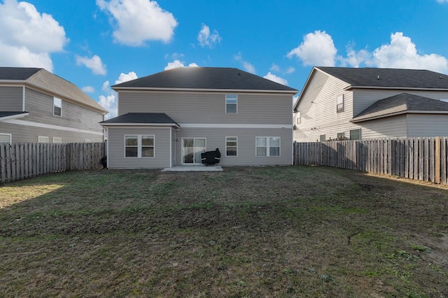 rear view of property featuring a patio area and a lawn