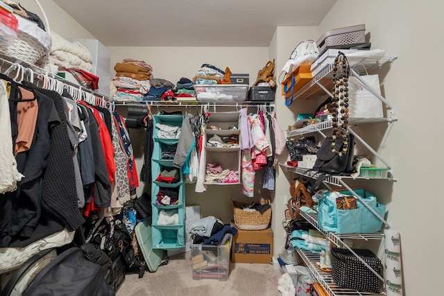 walk in closet featuring carpet flooring