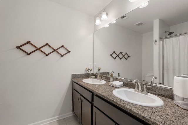 bathroom featuring curtained shower, tile patterned flooring, vanity, and toilet