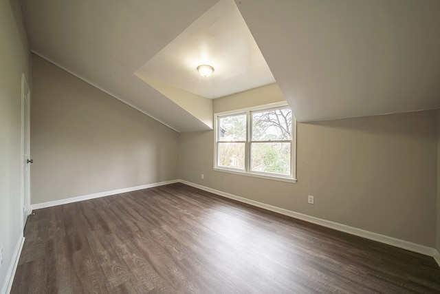 bonus room featuring dark hardwood / wood-style floors and vaulted ceiling