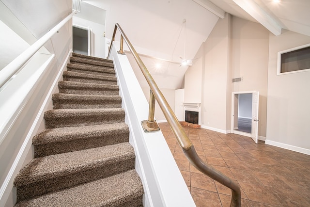 stairway featuring beamed ceiling and high vaulted ceiling