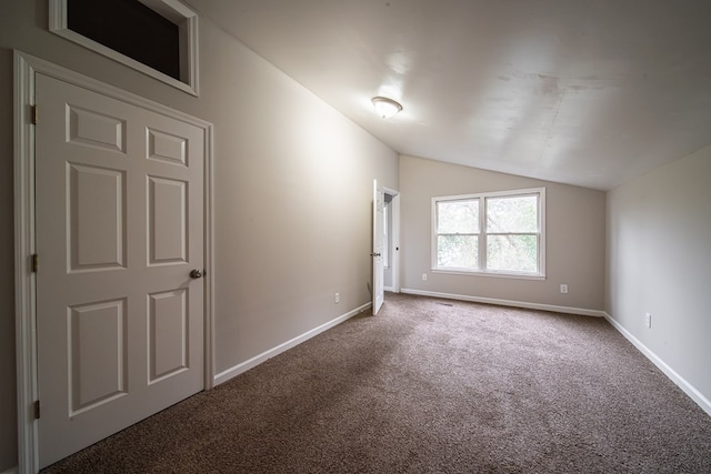 bonus room with vaulted ceiling and carpet