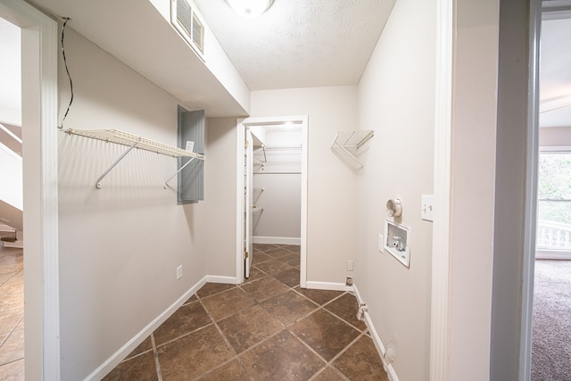 clothes washing area featuring hookup for a washing machine and a textured ceiling