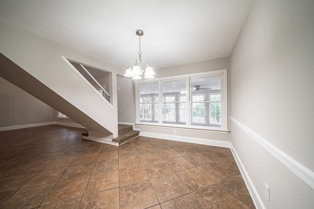 unfurnished dining area featuring a notable chandelier