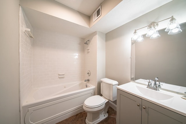 full bathroom featuring vanity, tile patterned flooring, toilet, and tiled shower / bath