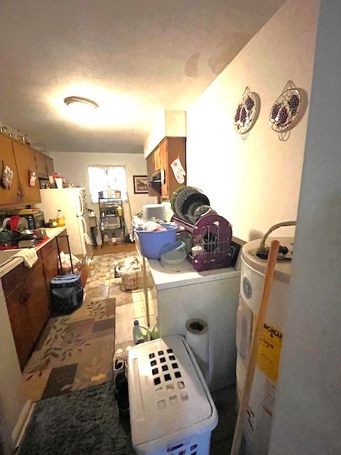 interior space featuring water heater and washer / dryer