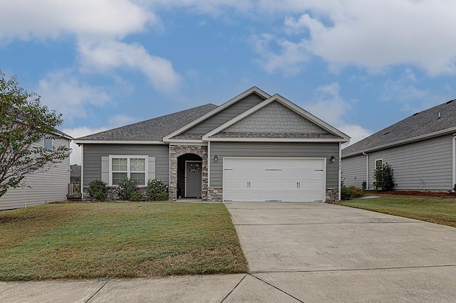 craftsman house with a front yard and a garage