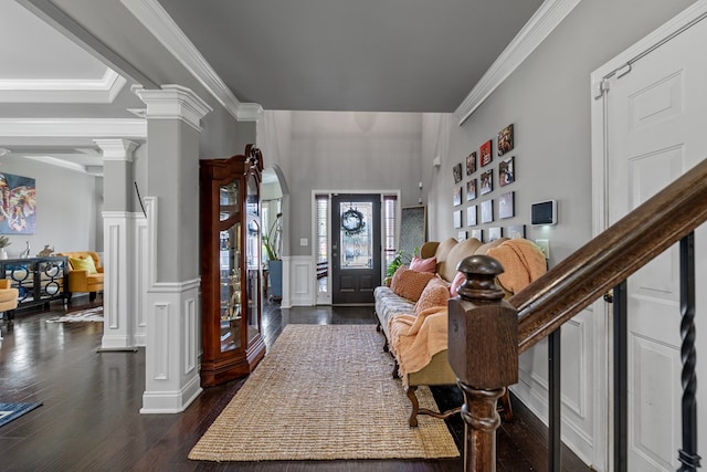 50 Riverside Lndg, Fort Mitchell, AL 36856 - foyer with decorative columns, dark wood-style flooring, a decorative wall, ornamental molding, and wainscoting