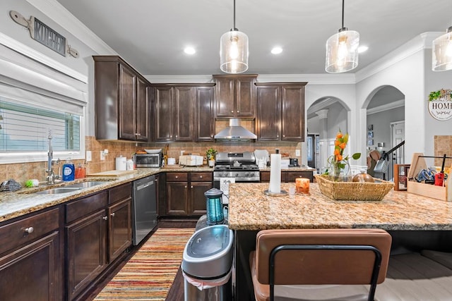 50 Riverside Lndg, Fort Mitchell, AL 36856 - kitchen with appliances with stainless steel finishes, wall chimney range hood, dark brown cabinets, light stone counters, and crown molding