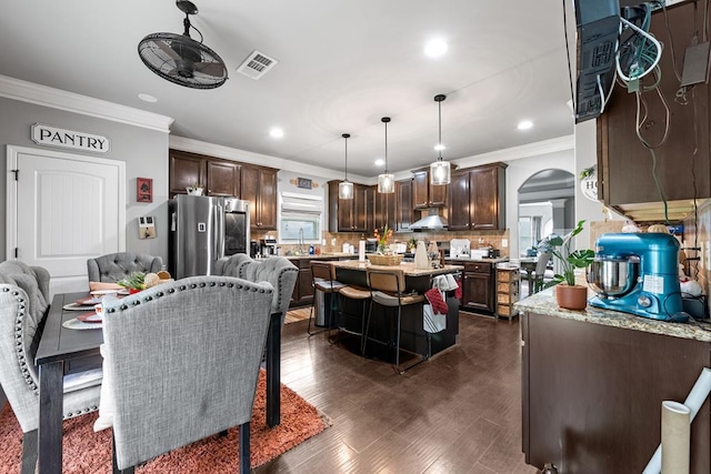 50 Riverside Lndg, Fort Mitchell, AL 36856 - dining space featuring arched walkways, crown molding, recessed lighting, and dark wood-style floors