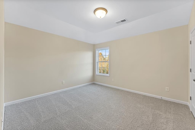 spare room featuring visible vents, baseboards, and carpet floors