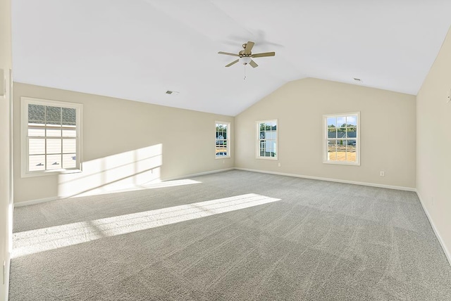 unfurnished room featuring visible vents, baseboards, ceiling fan, vaulted ceiling, and carpet flooring