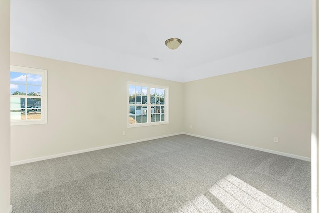 unfurnished room featuring baseboards and carpet floors