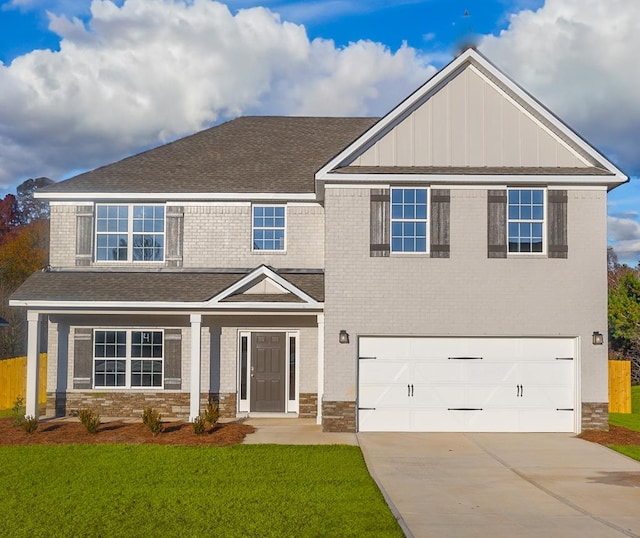 view of front of property with driveway, roof with shingles, an attached garage, a front lawn, and brick siding