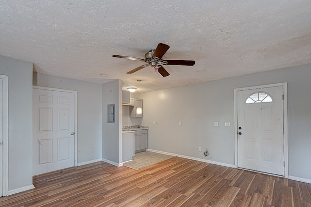 entryway with hardwood / wood-style flooring, ceiling fan, a textured ceiling, and electric panel