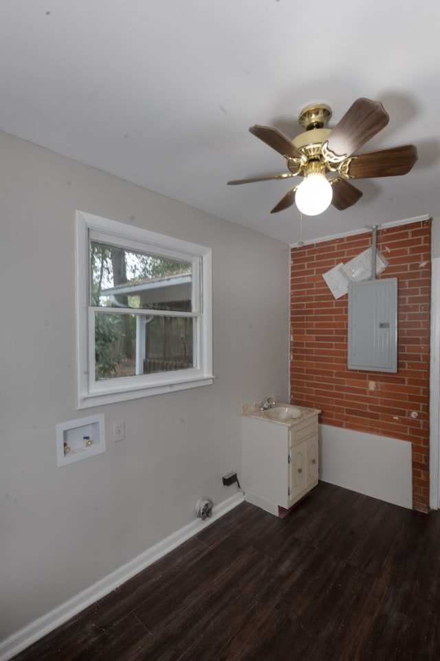 interior space featuring ceiling fan, sink, dark wood-type flooring, and electric panel