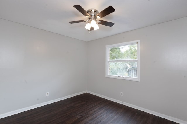 empty room with ceiling fan and dark wood-type flooring