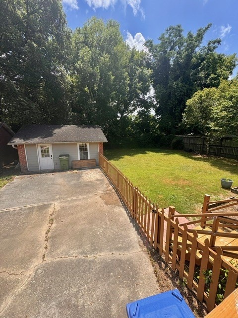 1616 Crest Dr, Columbus, GA 31906 - view of front facade featuring an outbuilding, view of scattered trees, and brick siding