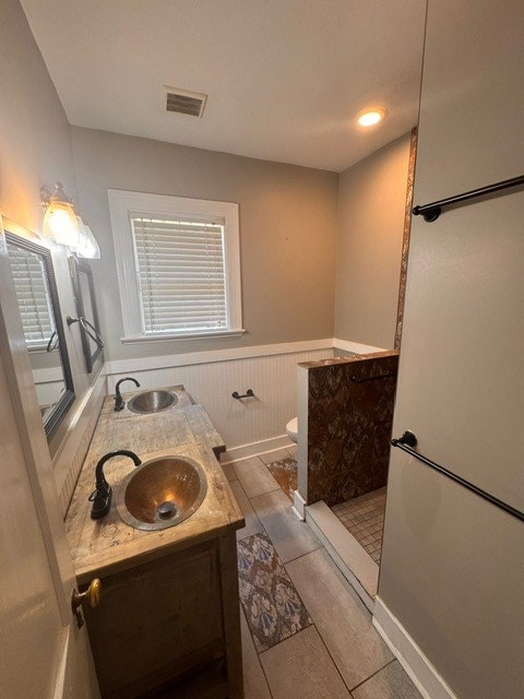 1616 Crest Dr, Columbus, GA 31906 - bathroom with a wainscoted wall and double vanity