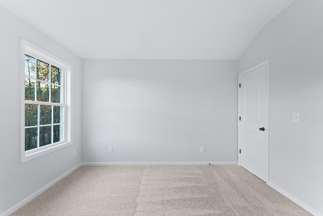 unfurnished room with lofted ceiling and carpet floors