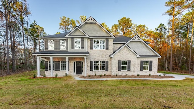 craftsman-style house featuring a porch and a front yard