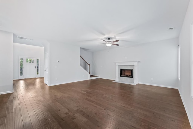 unfurnished living room featuring ceiling fan and dark hardwood / wood-style flooring