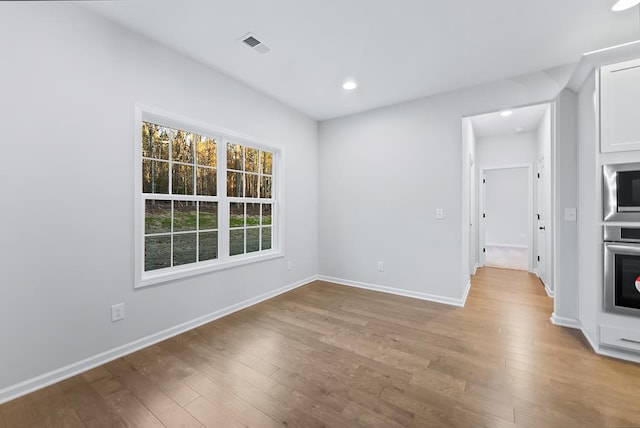 unfurnished room featuring light wood-type flooring