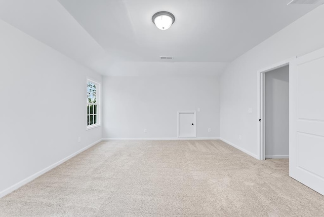 unfurnished room featuring light colored carpet