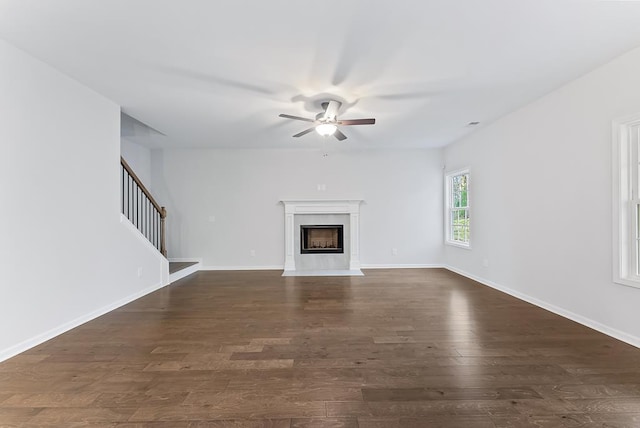 33 Oak Ridge Dr, Waverly Hall, GA 31831 - unfurnished living room featuring a ceiling fan, stairs, a high end fireplace, baseboards, and dark wood-style floors
