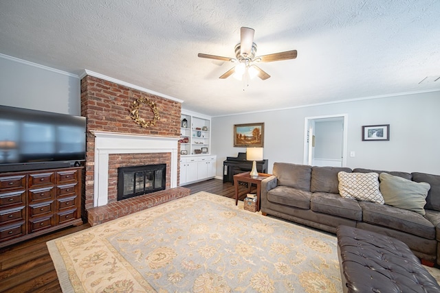 living room featuring crown molding, a textured ceiling, dark wood-type flooring, and a fireplace