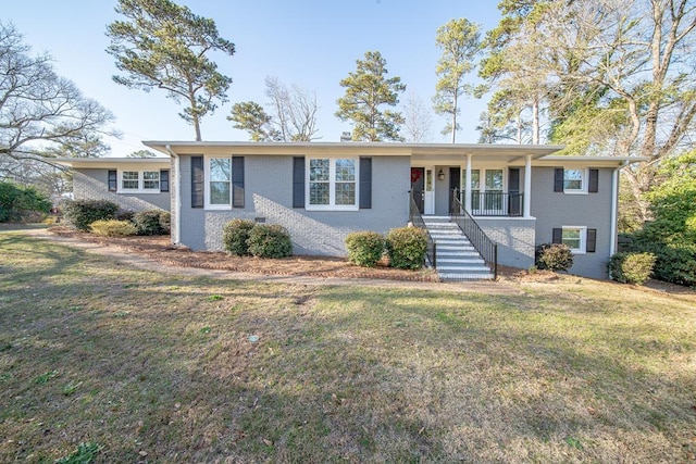 ranch-style home featuring stairs, a front lawn, a porch, and brick siding