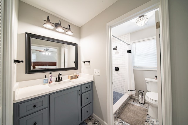 bathroom featuring baseboards, toilet, a shower stall, and vanity