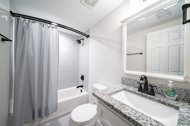 bathroom with vanity, shower / tub combo, toilet, and visible vents