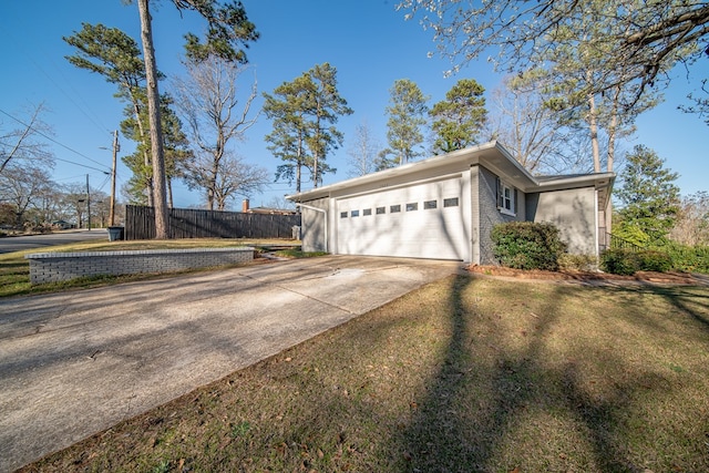 exterior space with fence, driveway, a garage, a lawn, and brick siding