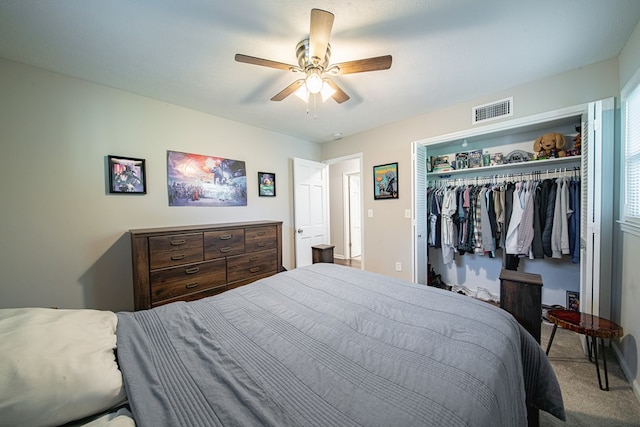 bedroom with visible vents, a closet, ceiling fan, and carpet flooring