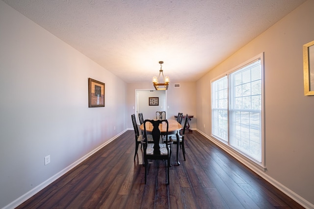 dining space featuring a chandelier, baseboards, and dark wood-style floors