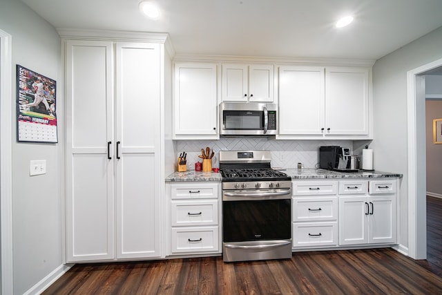 kitchen featuring white cabinets, stainless steel appliances, and dark wood-type flooring