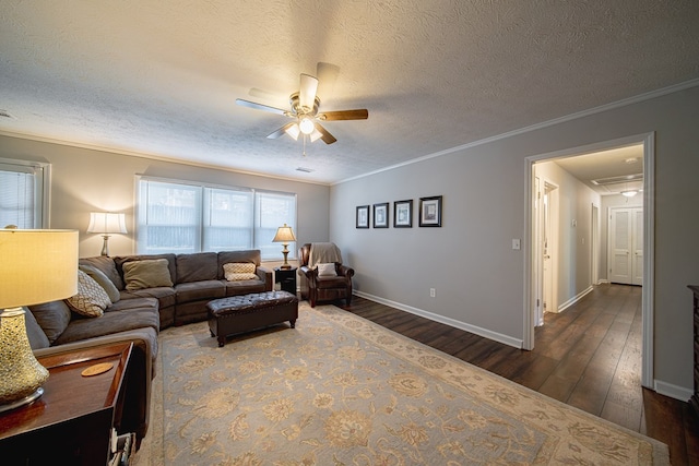 living area featuring crown molding, dark wood-type flooring, and a ceiling fan