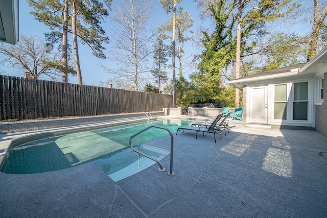 view of swimming pool featuring a fenced in pool, a patio, a fenced backyard, and french doors