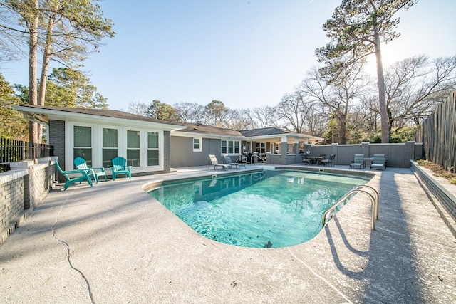 view of pool with a patio area, a fenced in pool, and a fenced backyard